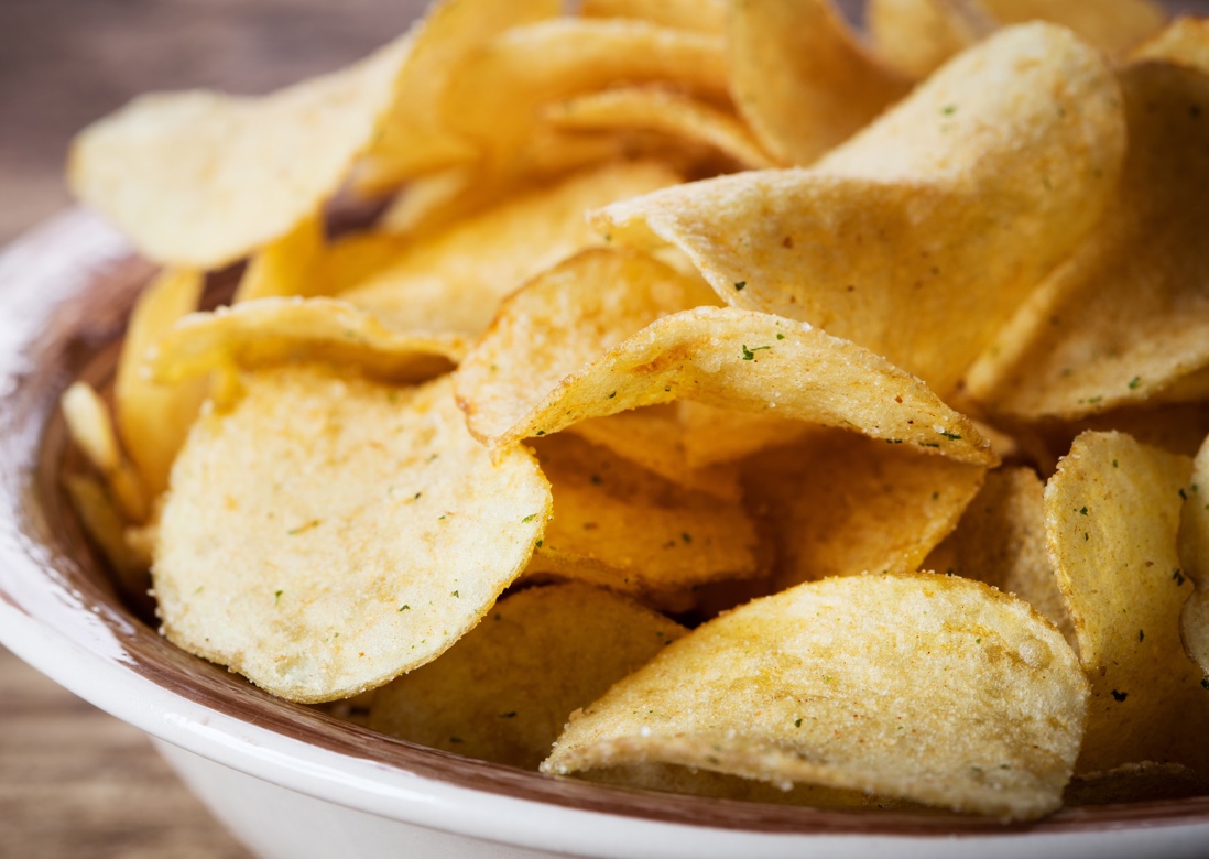 A bowl of fresh chips sitting on a table.